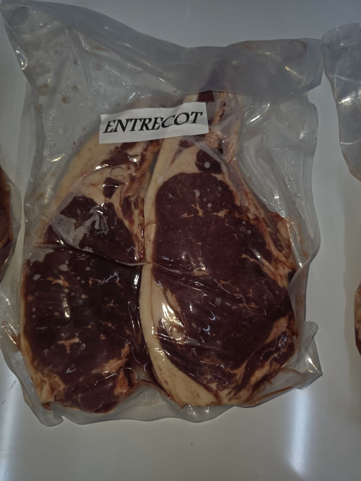 Dos entrecots de buey al vacío, con el borde de grasa cremosa